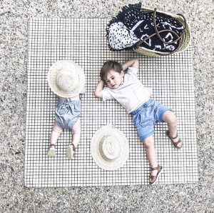 Two young brothers laying out at a picnic