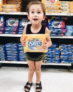 Toddler boy holding birthday cake Oreos