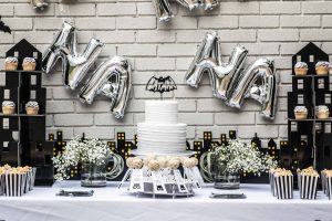 Batman kids' birthday party decor; cake, cupcakes, popcorn, and cake pops