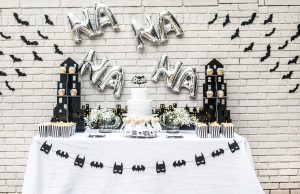 Batman kids' birthday party decor; cake, cupcakes, popcorn, and cake pops